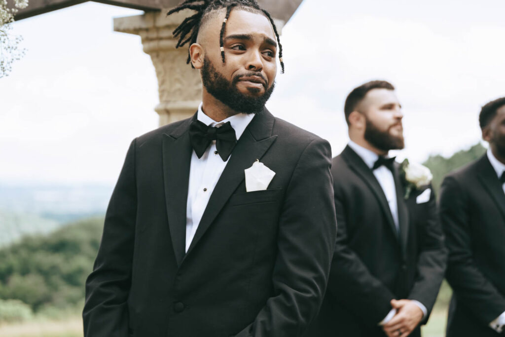 cute picture of the groom emotional watching the bride walk down the aisle 