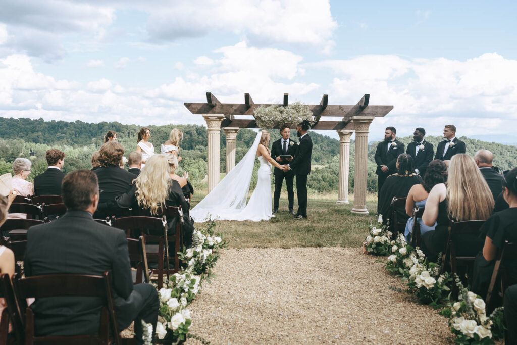 bride and groom holding hands at their ceremony 