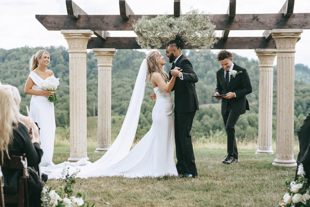 bride and groom kissing after their wedding ceremony 