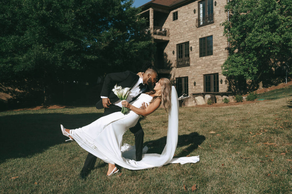 picture of the bride and groom kissing 