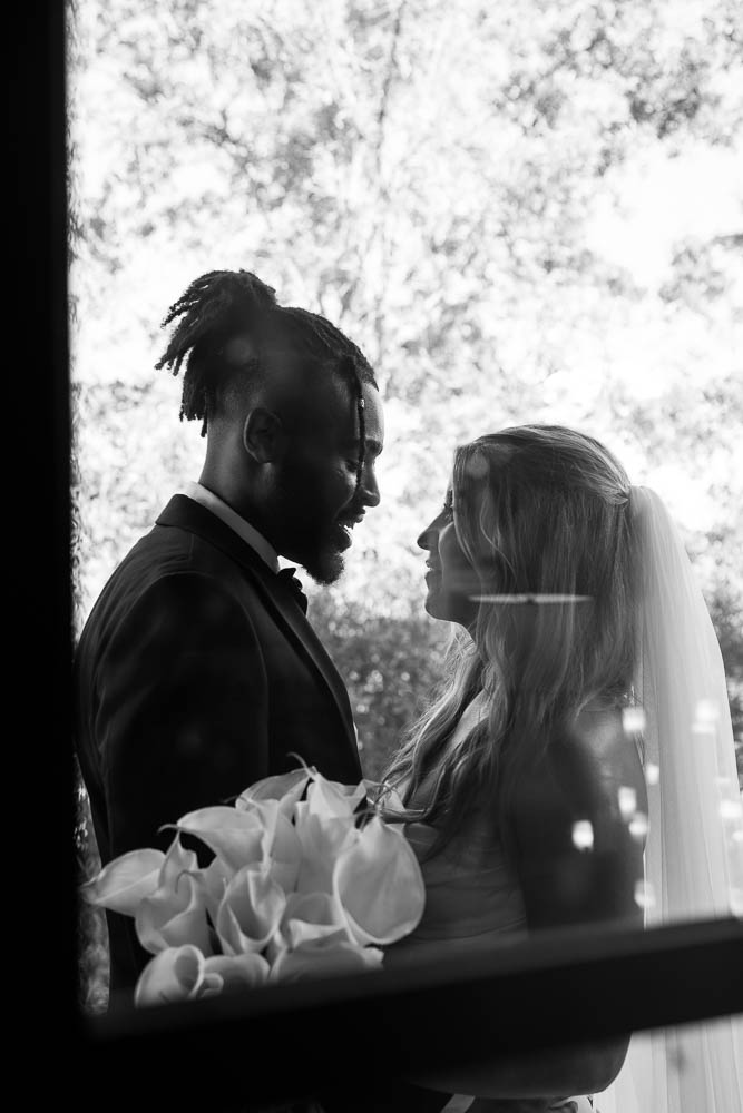 b&w portrait of the bride and groom looking at each other