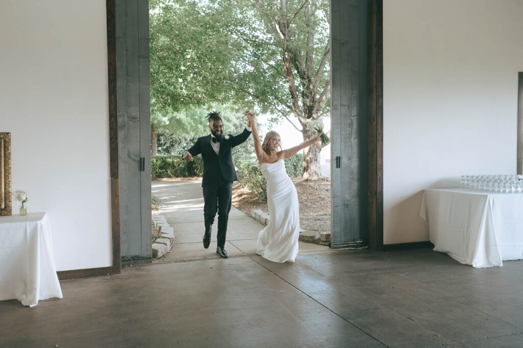 newlyweds entering their reception