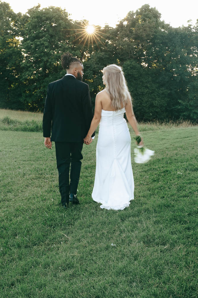 cute couple walking around their wedding venue 