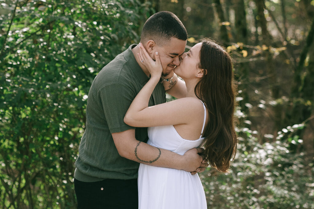 fiance kissing her fiancé on the cheek 