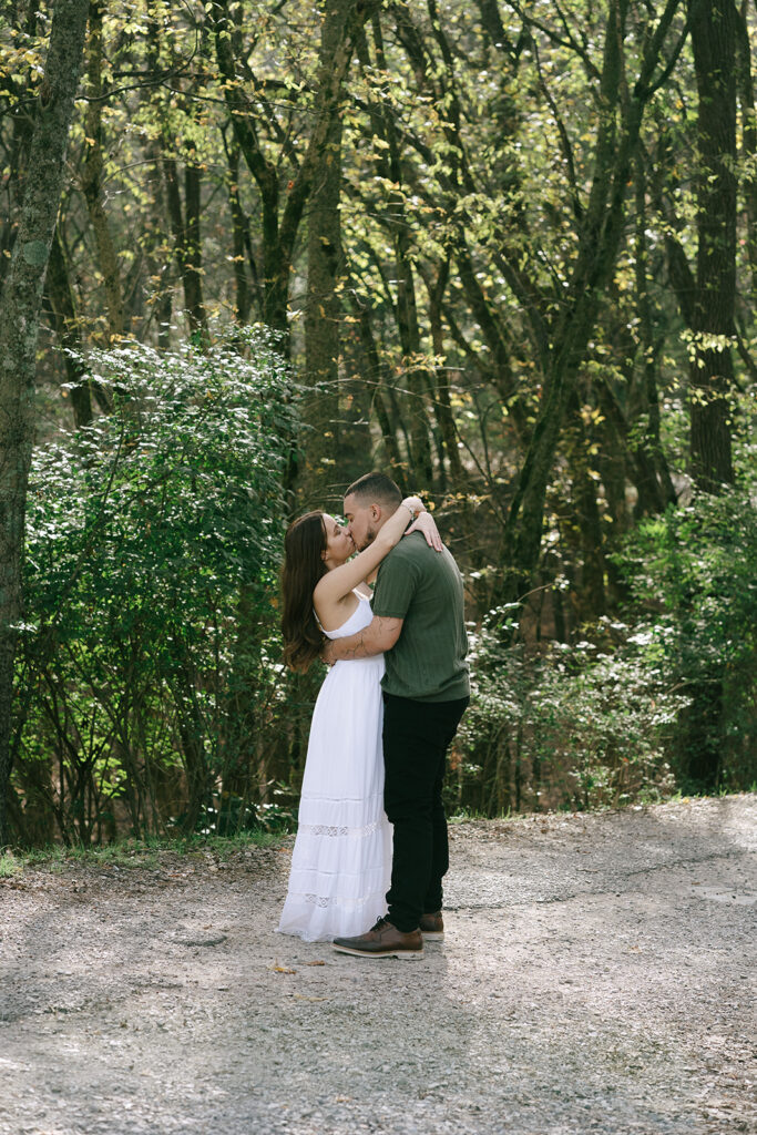 cute couple kissing at their engagement photoshoot