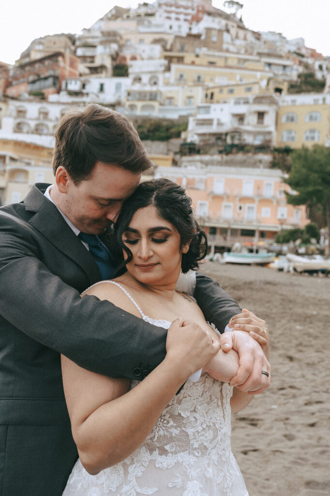 portrait of the bride and groom hugging 