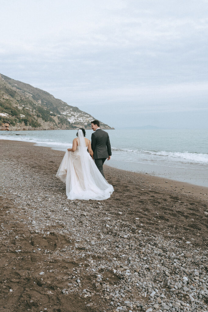 couple walking around the coast during their bridal portraits 