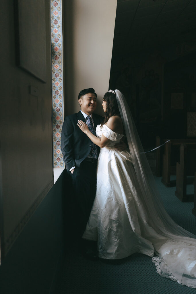 bride and groom laughing with each other during their photoshoot