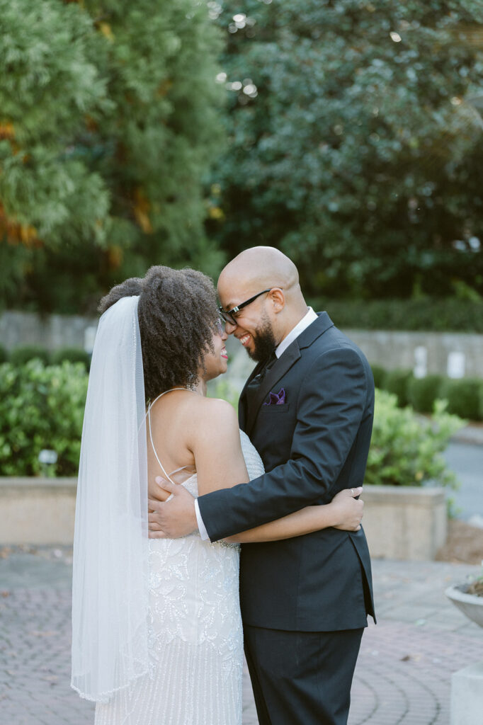 cute portrait of the bride and groom laughing with each other during their bridsl portraits