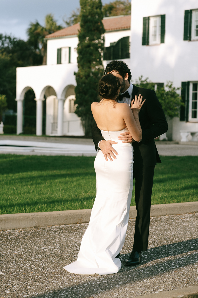 portrait of the newlyweds kissing at their reception party