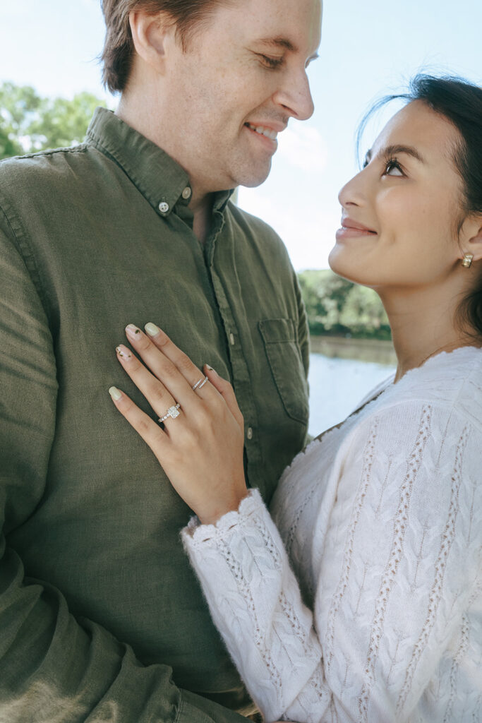 cute couple smiling at each other during their photoshoot