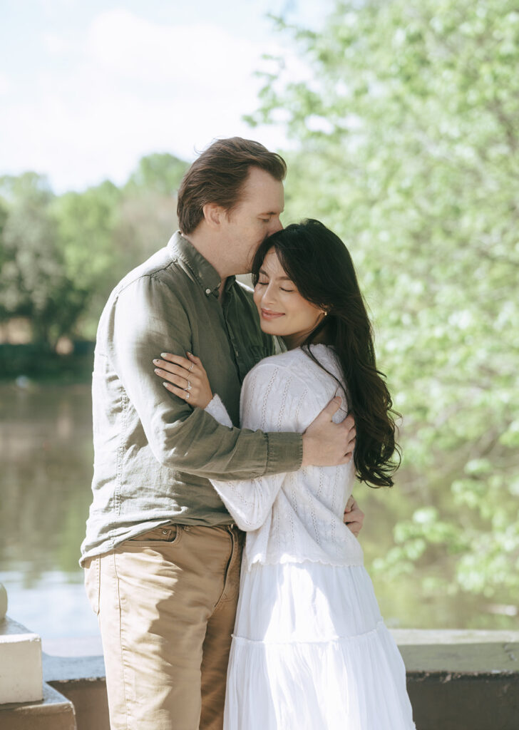 fiance kissing his fiance on the forehead