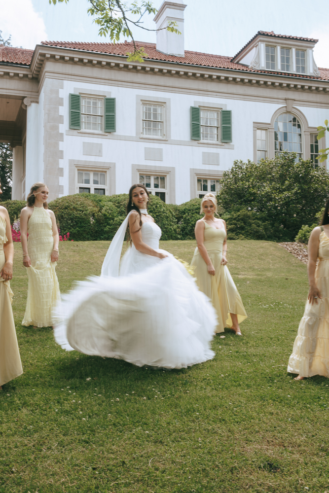 bride and her bridesmaids dancing during their photoshoot