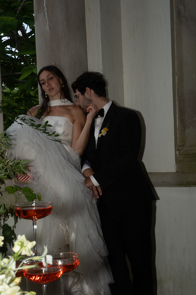 groom kissing the bride on the shoulder