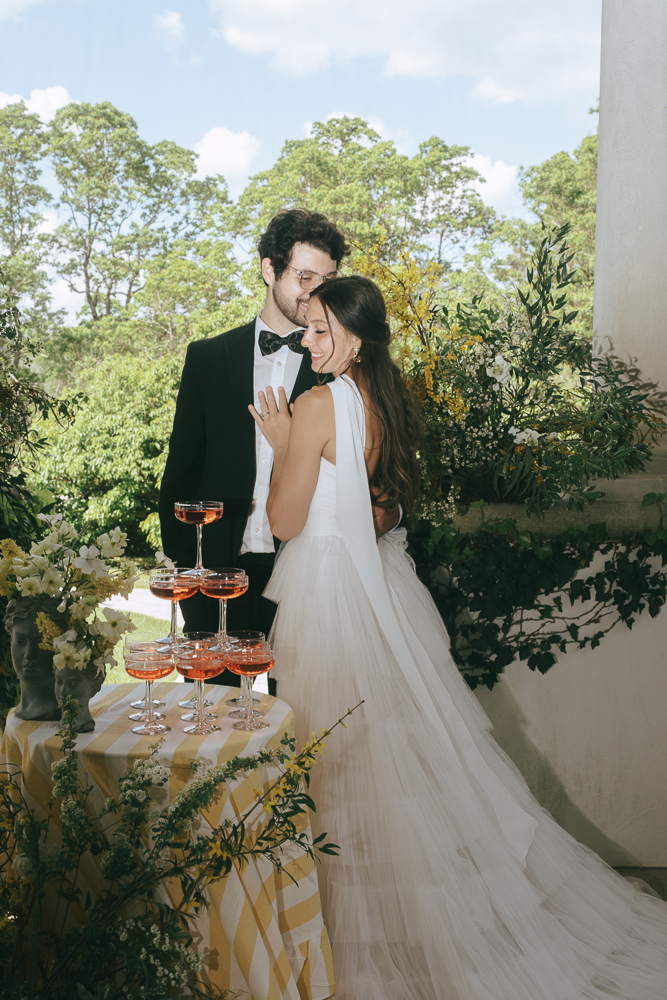 bride and groom celebrating with a champagne tower