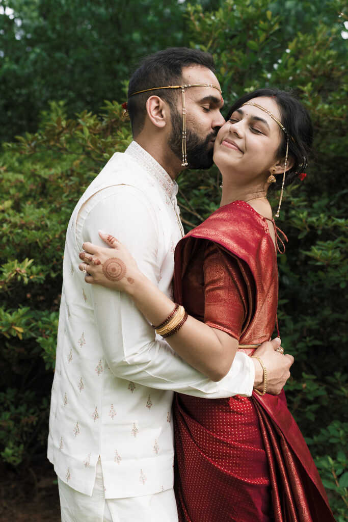 groom kissing the bride on the cheek