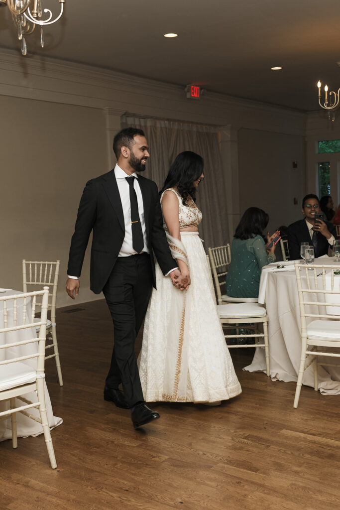 newly married couple arriving at their reception