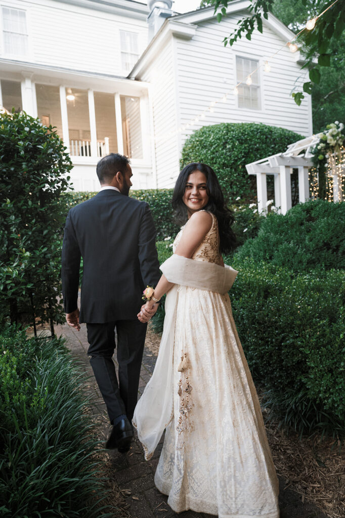 cute picture of the newlyweds walking around their dream wedding venue