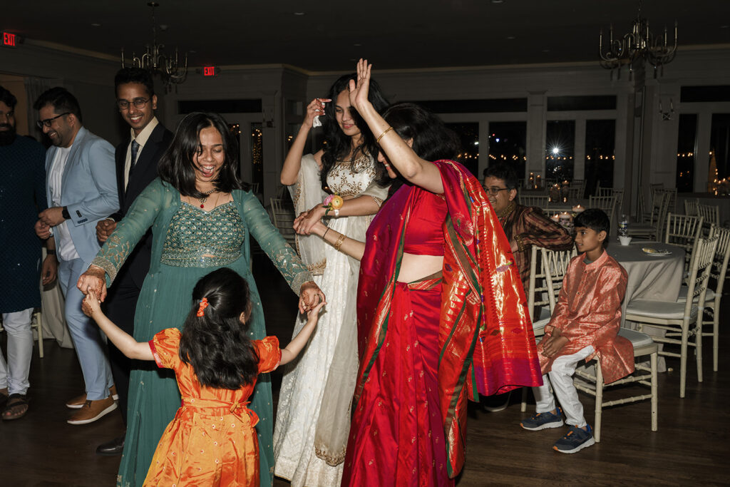 bride dancing with her mom and sisters at the reception party