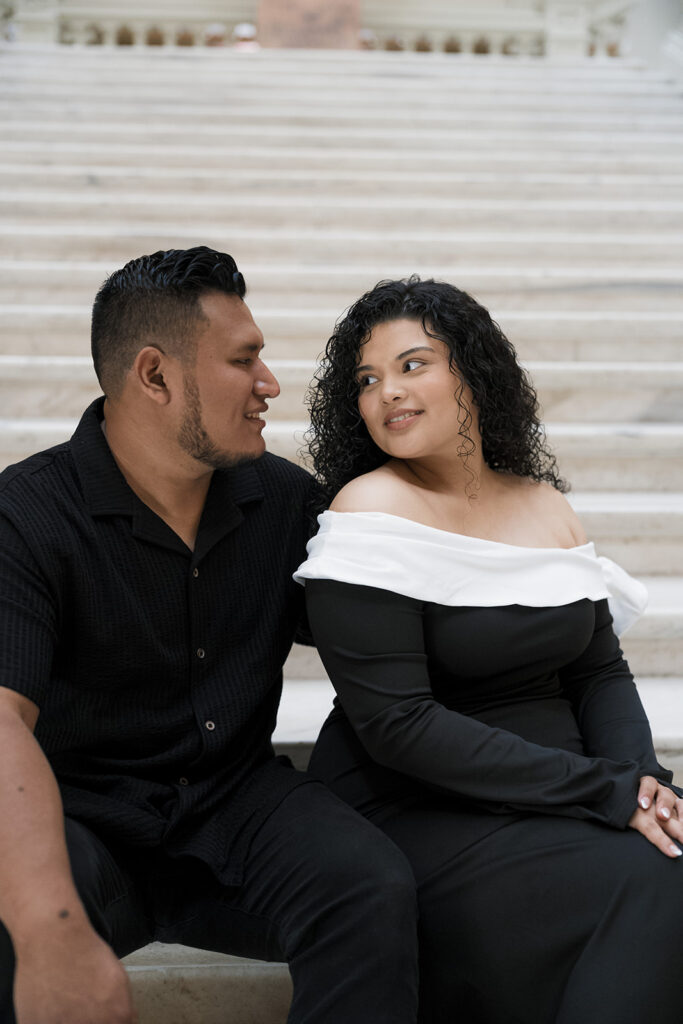 Couple smiling at each other during their photoshoot