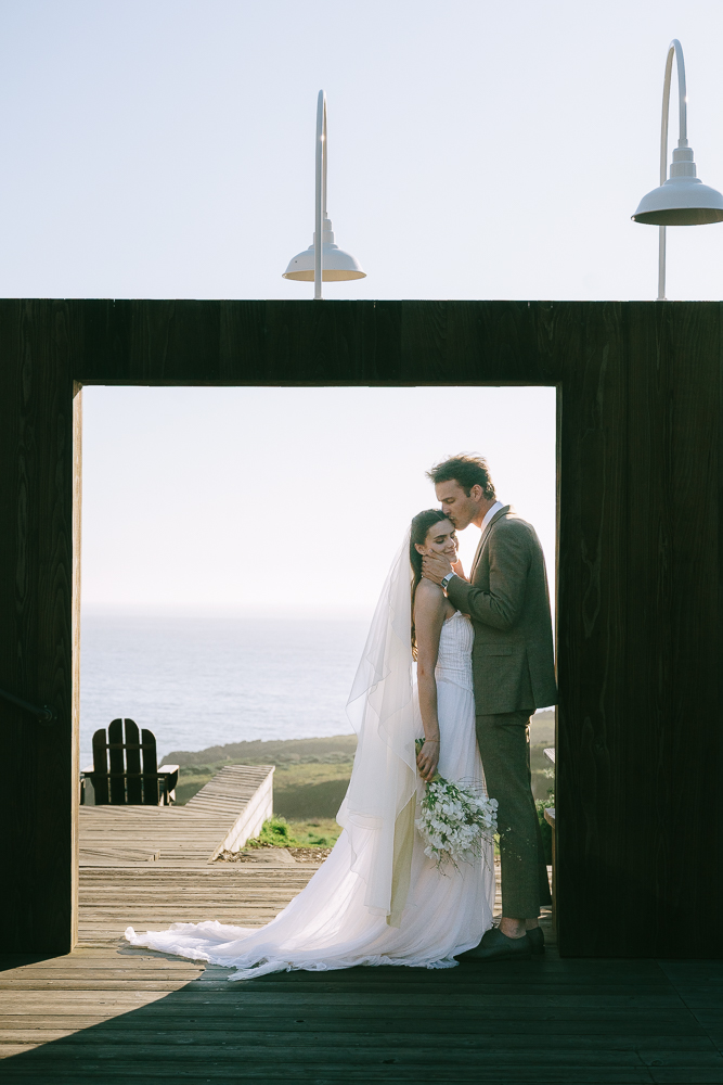 picture of the groom kissing the bride on the forehead