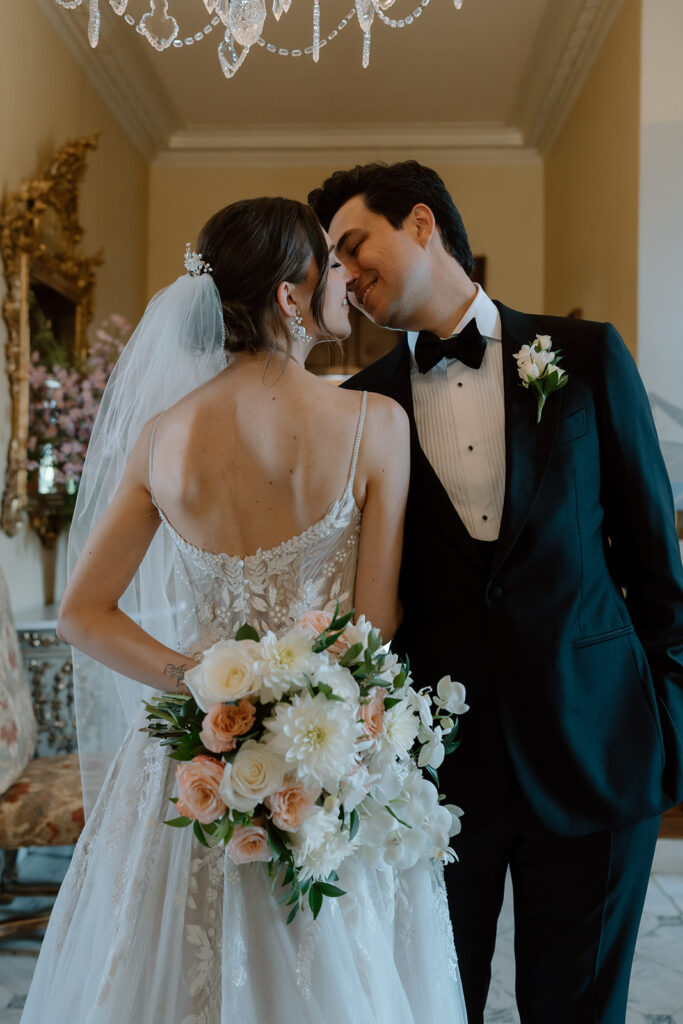 portrait of the newlyweds kissing before heading to their reception