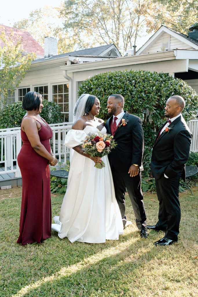 Picture of the bride and groom, laughing with their bridal party
