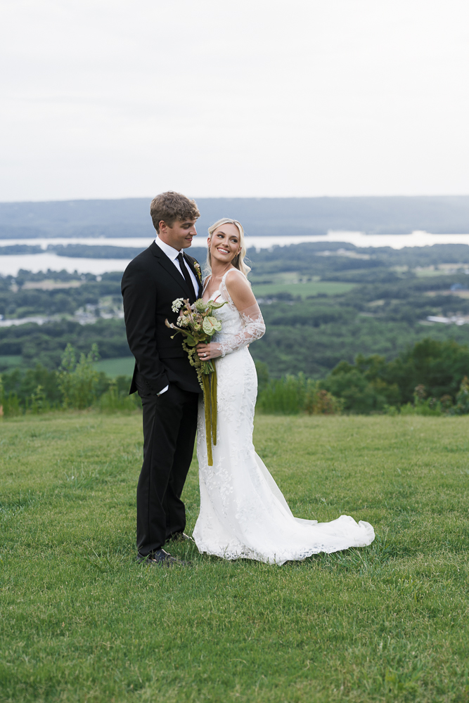 cute picture of the newlyweds smiling to each other during their session