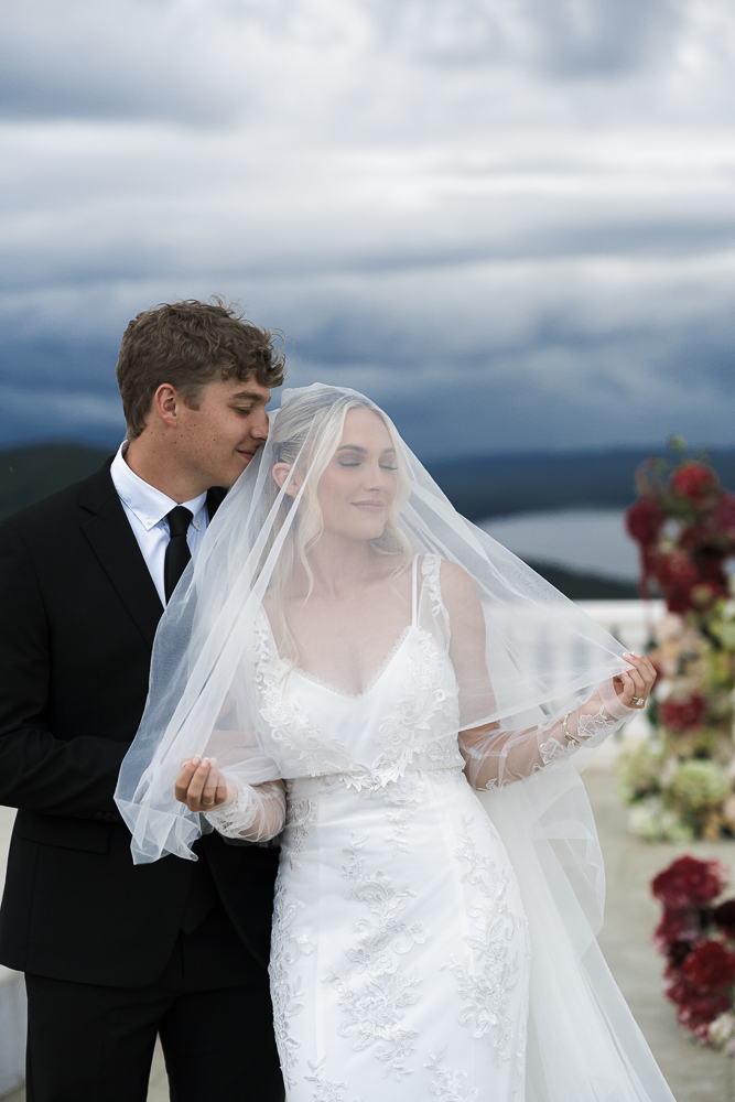 groom kissing the bride on the cheek