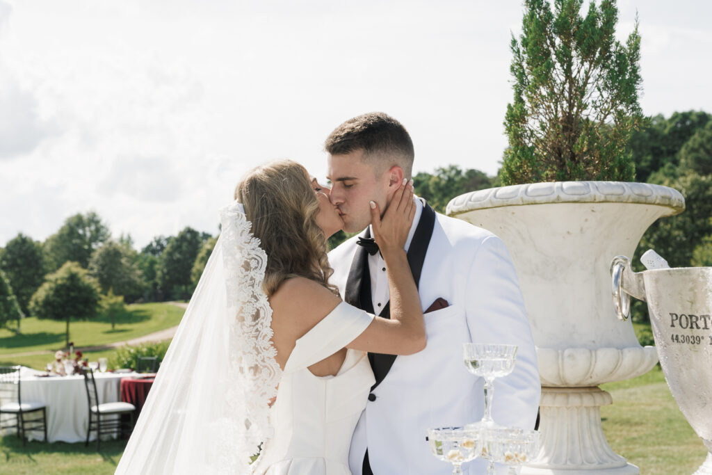 portrait of the bride and groom kissing 