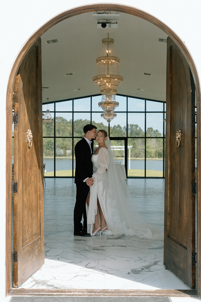 Groom, kissing the bride on the forehead