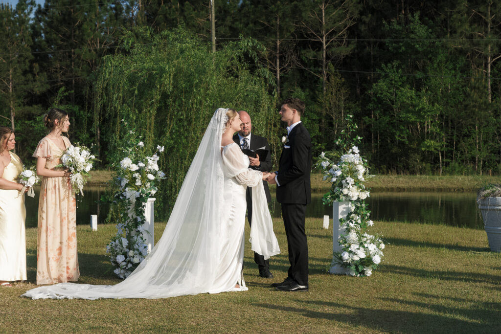 Bride and groom holding hands during their ceremony