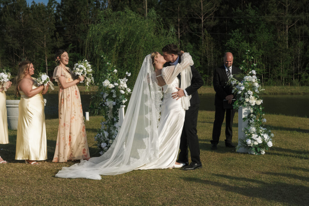 portrait of the bride and groom kissing after their ceremony