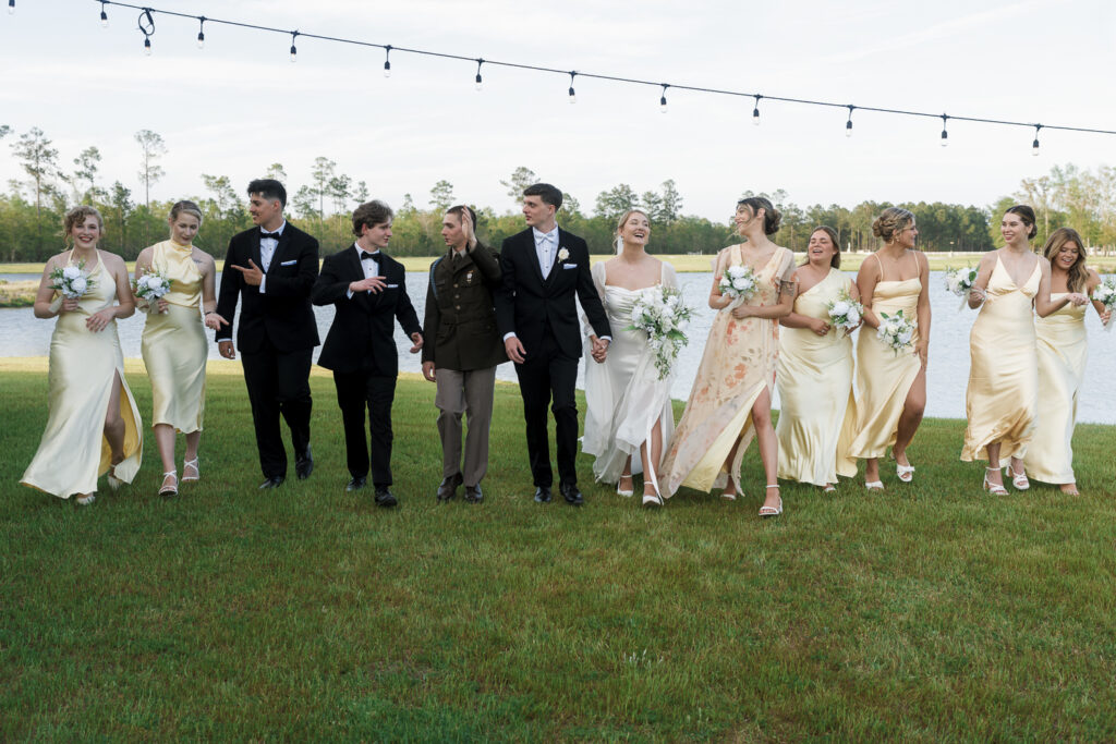 Fun picture of the bride and groom with their bridesmaids and groomsmen