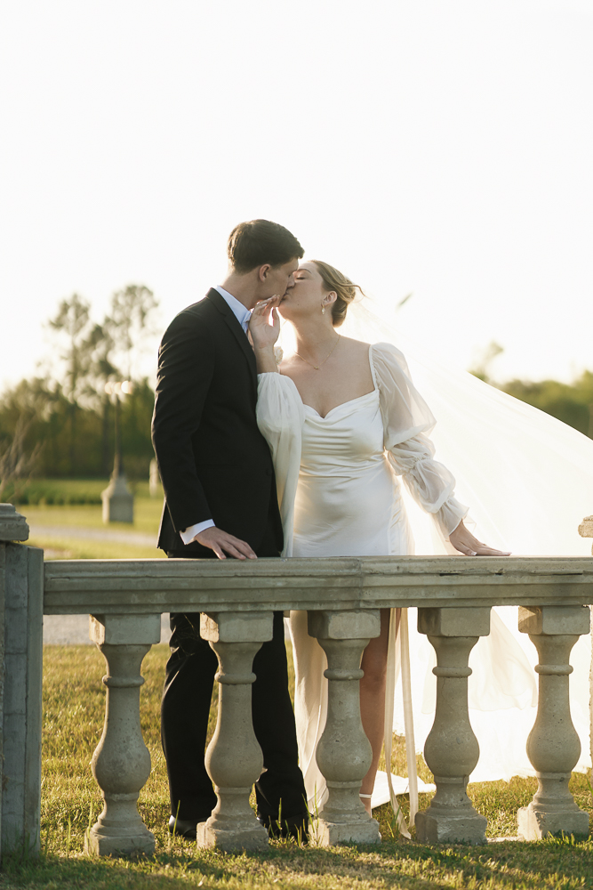 portrait of the newlyweds kissing