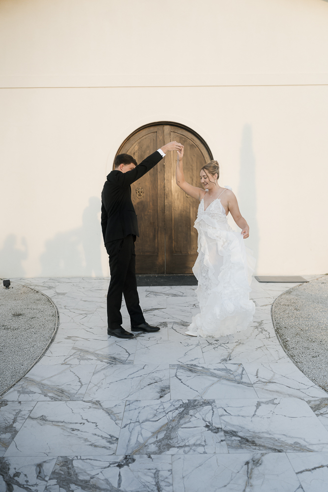 Cute picture of the newlyweds dancing during their photo shoot