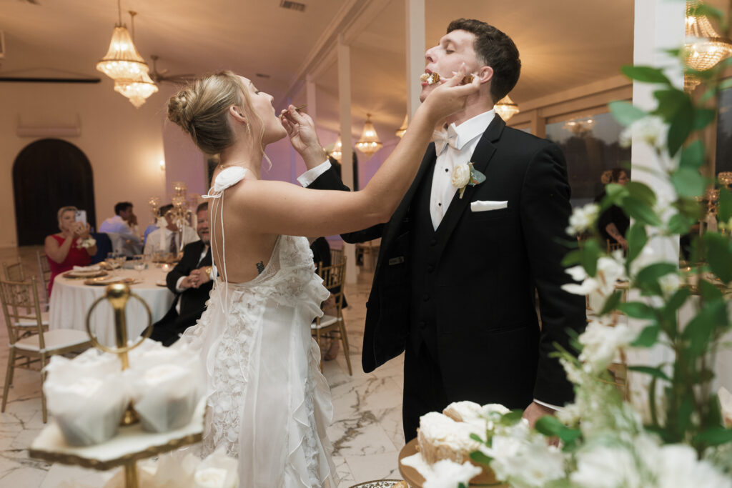 Newly married couple trying their wedding cake