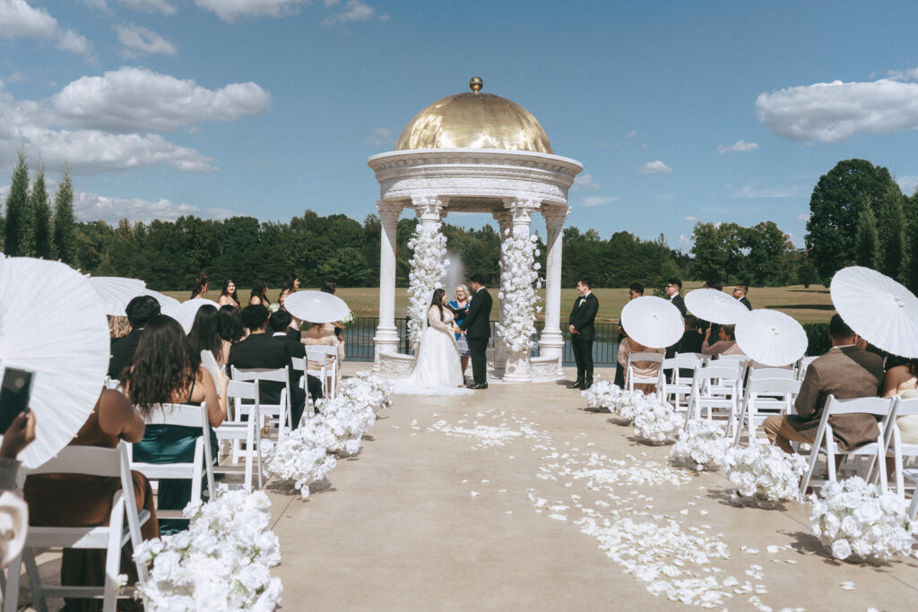 picture of the bride and groom holding hands during their wedding ceremony