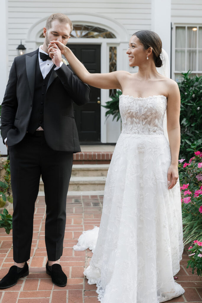 groom kissing the brides hand