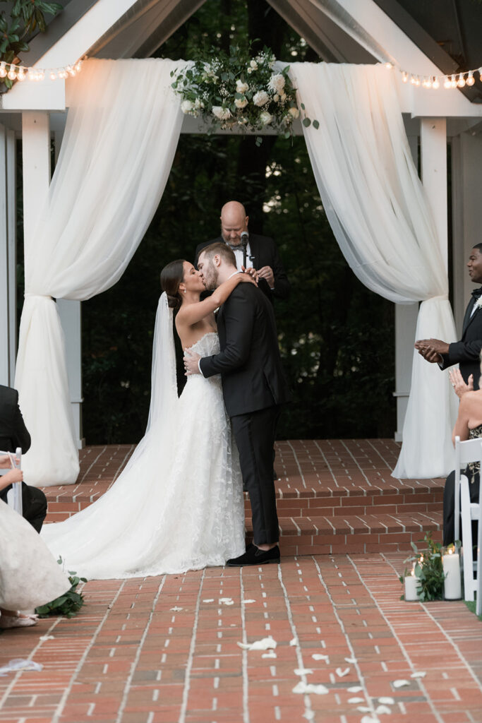 Bride and groom, kissing after their ceremony