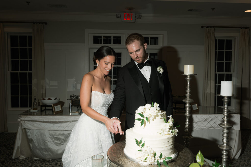 newly married couple cutting their wedding cake