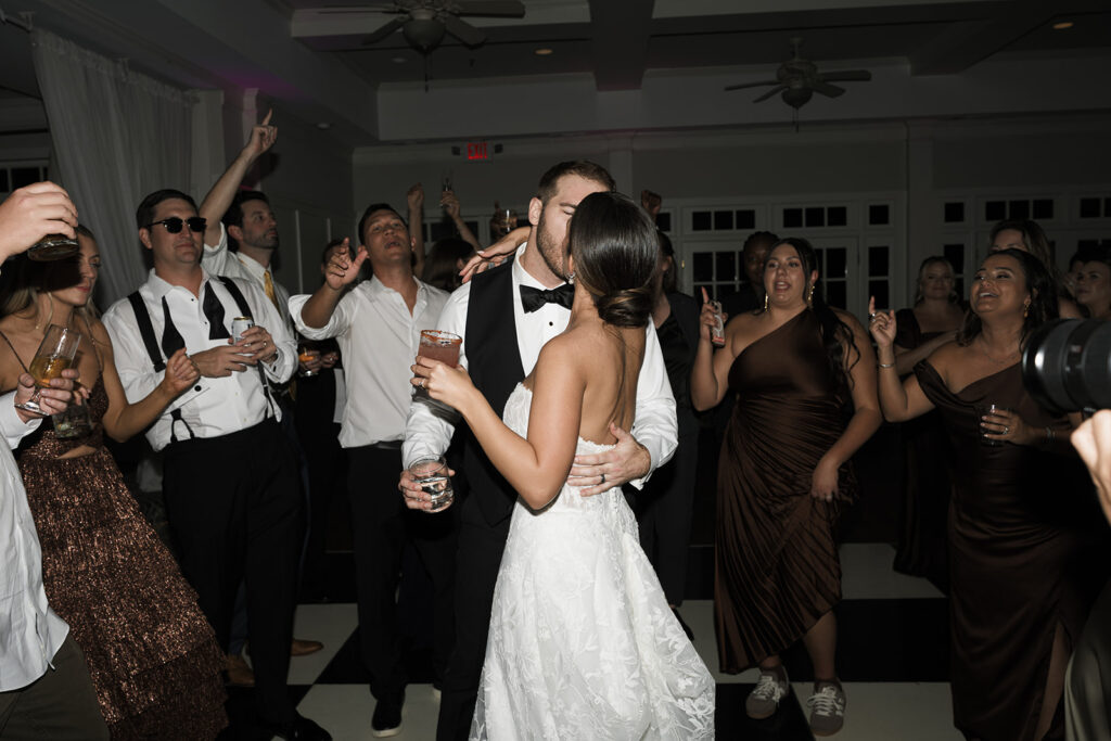 newly married couple kissing at their wedding reception