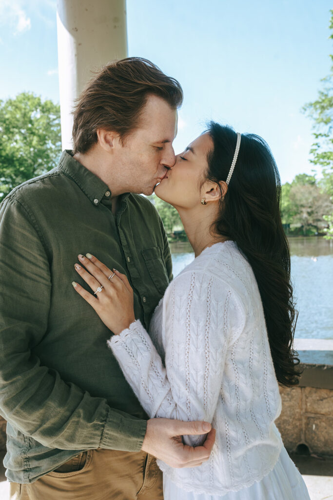 newly engaged couple kissing