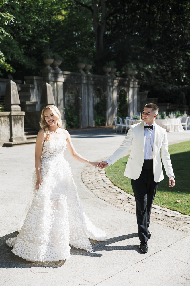 newlyweds walking around their dream wedding venue