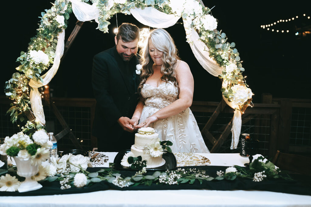 cute picture of the newlyweds cutting their wedding cake