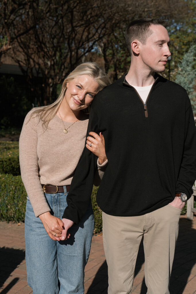 couple holding hands walking around the garden during their photoshoot