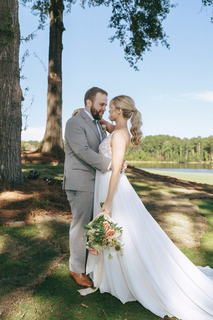 portrait of the bride and groom smiling at each other