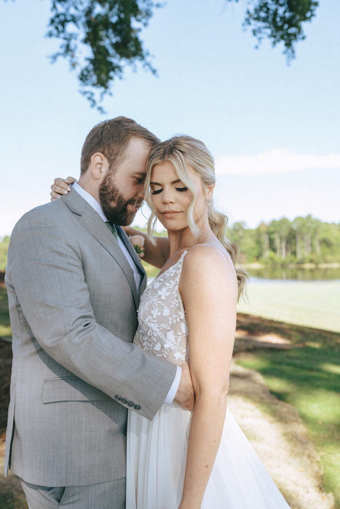 groom kissing the bride on the forehead