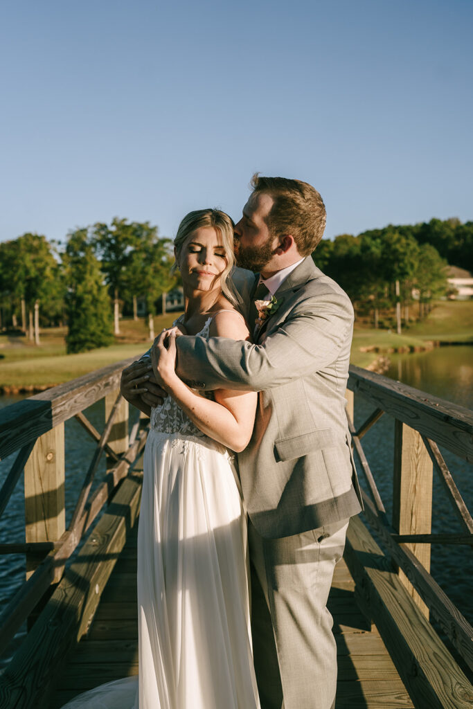 groom kissing the bride on the cheek