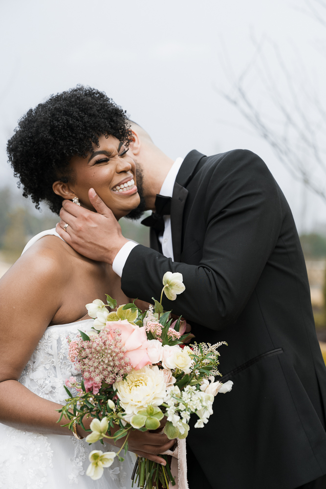 Groom, kissing the bride on the cheek